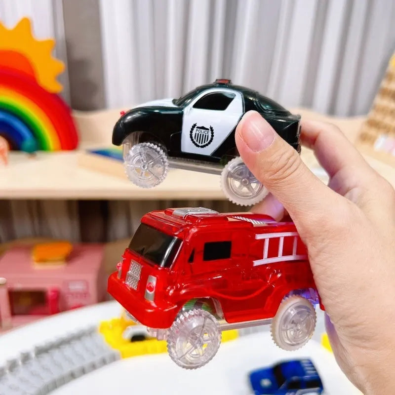Red electric fire truck rail car with front and rear lights on toy track