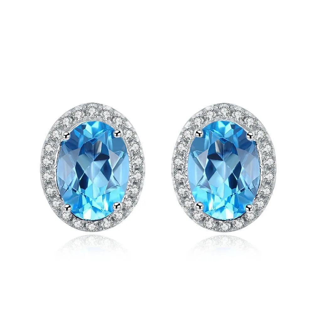 925 sterling silver four-piece jewellery set with blue topaz gems showing geometric-designed earrings, ring, pendant, and necklace