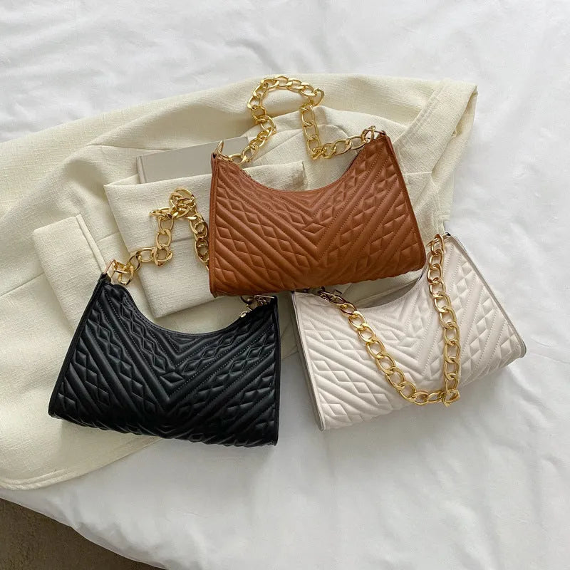 Brown pleated chain baguette shoulder bag showing vertical square shape and soft carry handle
