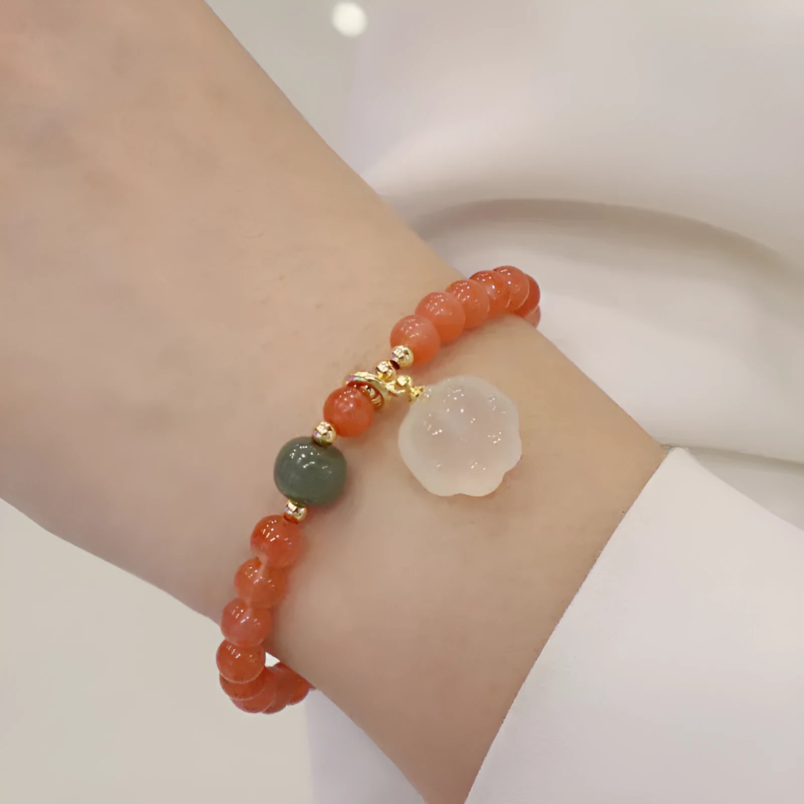 Natural red agate bracelet with 6mm beads and 8mm cat paw charm featuring gemstone inlay