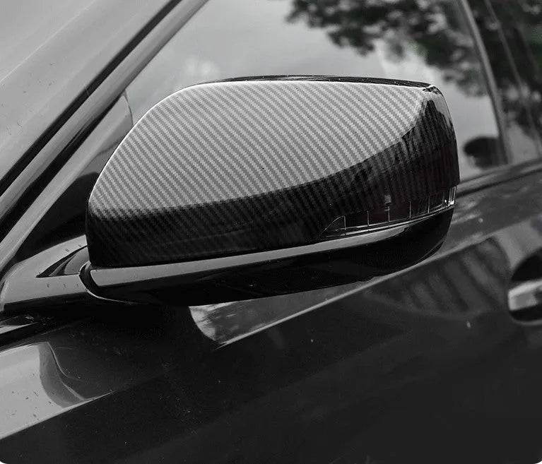 Pair of ABS plastic rearview mirror covers for Cadillac CT5 and CT6 cars in carbon fibre pattern finish.