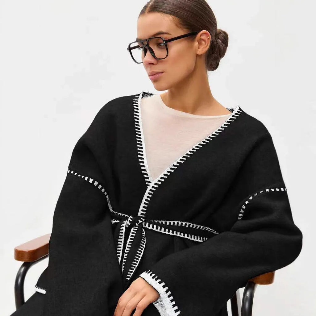 Loose mid-length knitted cardigan with lace-up front, in white, black, or camel.