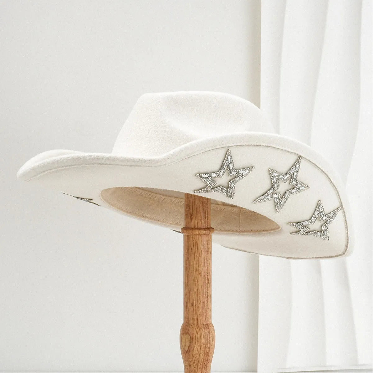 Beige woven polyester western-style top hat with a conical crown on a neutral background.