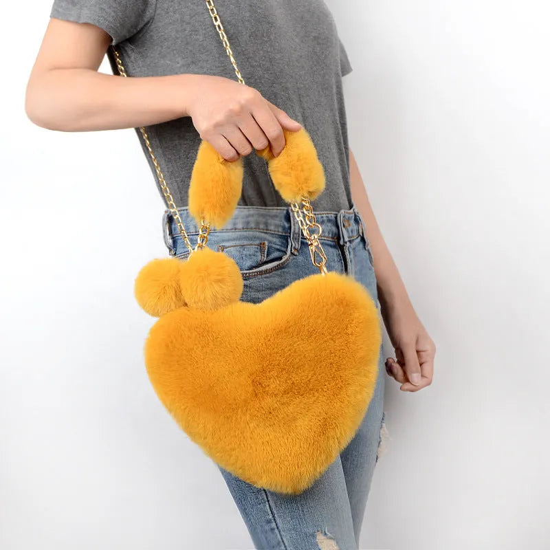 Women's soft plush heart-shaped handbag in medium size with adjustable shoulder strap