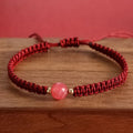 Woven red rope bracelet with alloy beads and natural strawberry quartz or obsidian stone beads