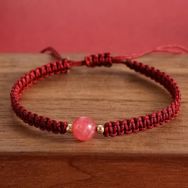 Woven red rope bracelet with alloy beads and natural strawberry quartz or obsidian stone beads
