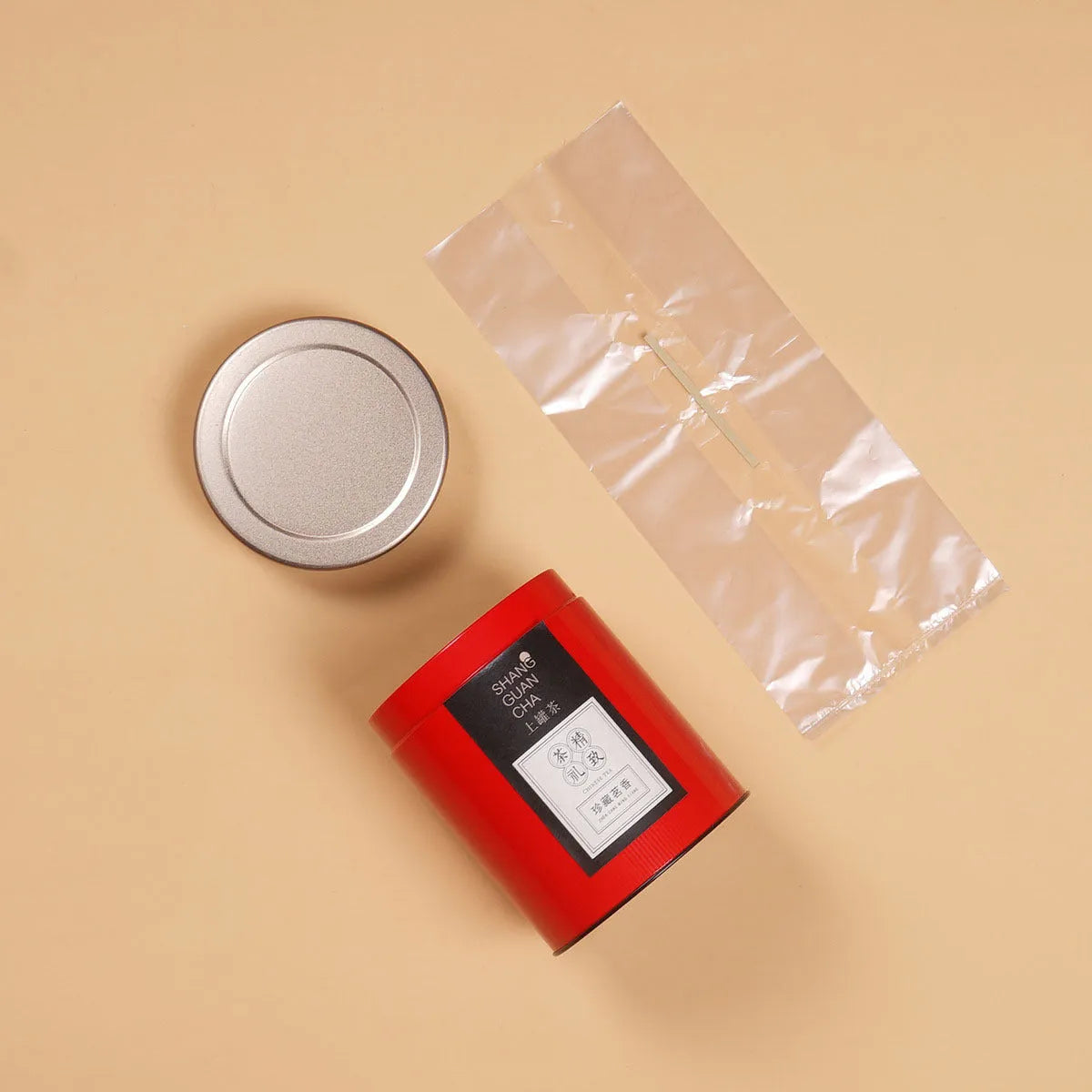 Green metal tin can tea packing box with sealed lid showing measurements of 155mm height and 85mm diameter