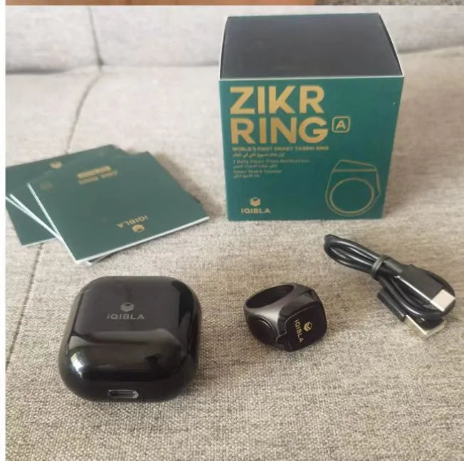 Zikr1 metal smart ring with OLED screen on a finger, showing tasbih count.