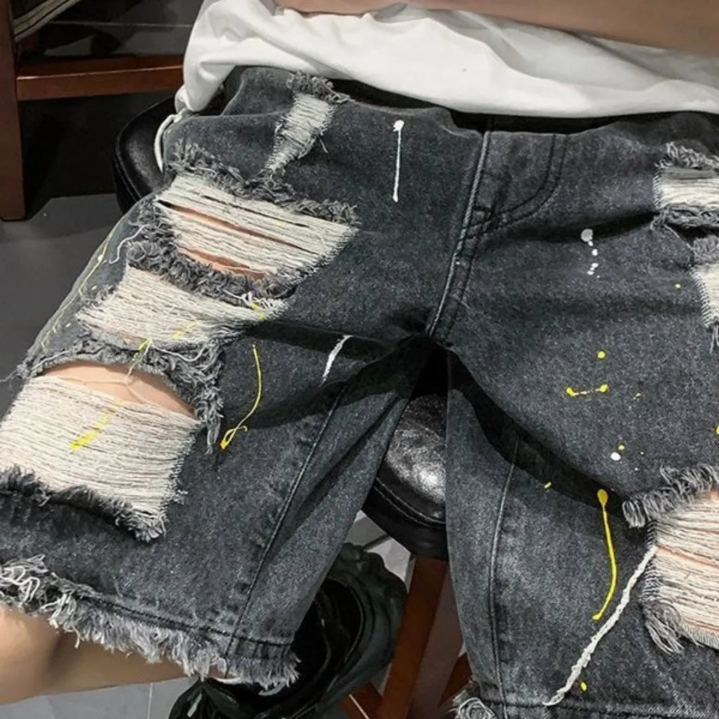 Men's loose fit light blue denim shorts with water washed hole design and fifth pants length.