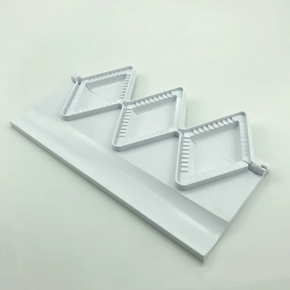 Pure white plastic dumpling maker 28.5 cm long on a kitchen countertop