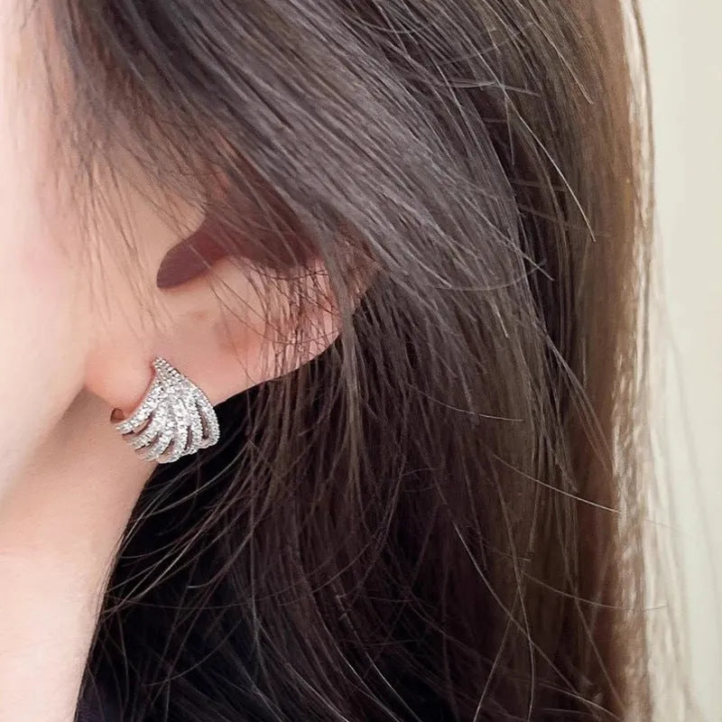 A pair of platinum-coloured geometric line design zircon earrings.