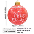 Large red inflatable Christmas ball with snowflake design in garden setting with flashing LED lights