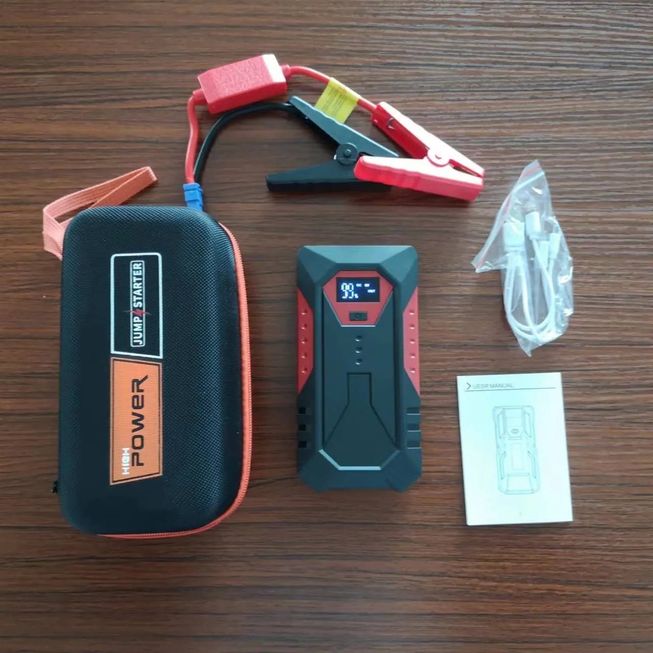 Red 12V car emergency jump starter power bank with battery clamps