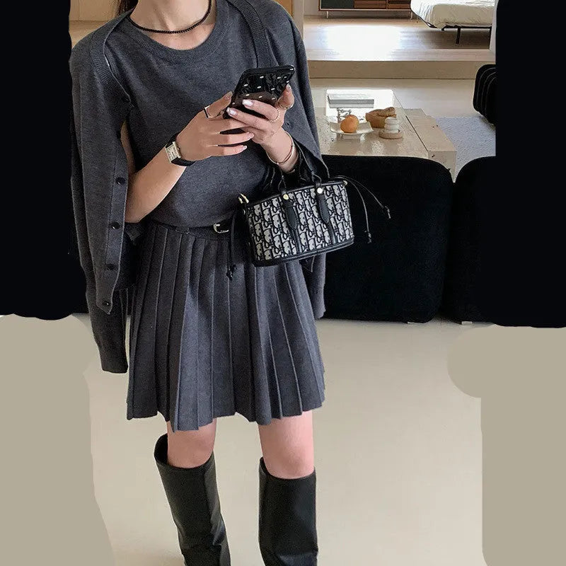 Grey women's knitted vest skirt and cardigan two-piece set with 3D pattern and belt.