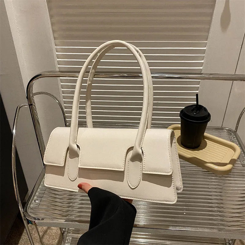 Women's small square shoulder bag in PU leather showing document compartment interior and stitching detail