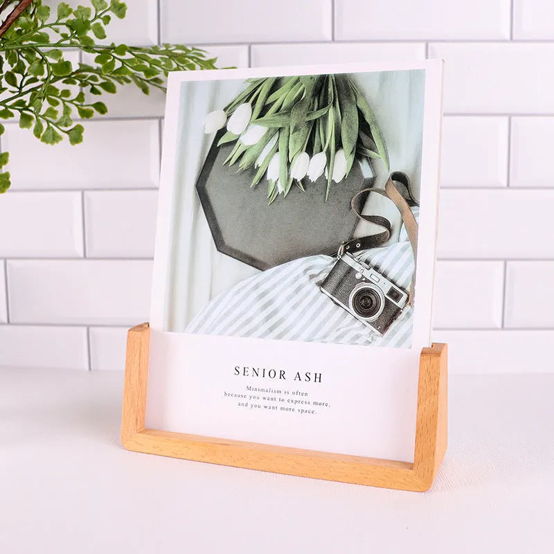 Wooden U-shaped luminous display stand with warm light holding a photo on a desk
