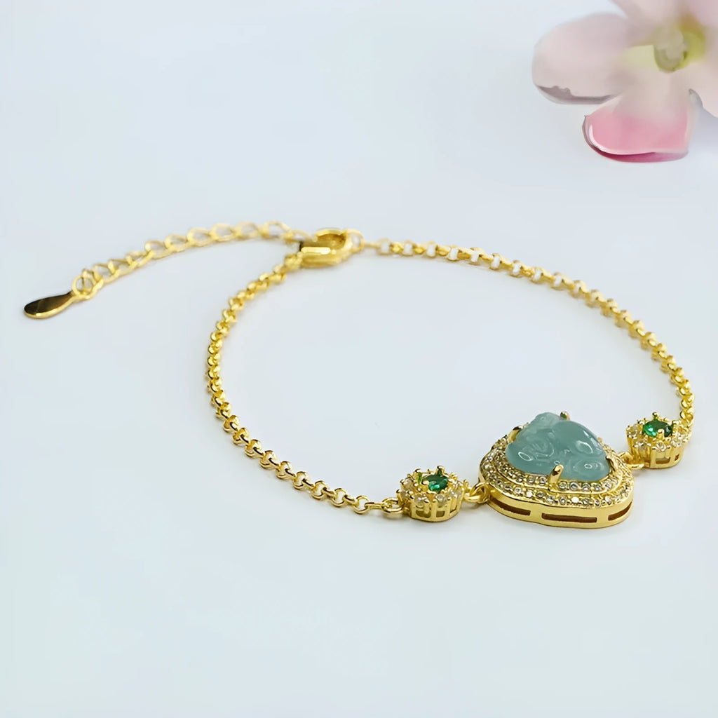 Close-up of a blue jade Maitreya Buddha pendant on a women's bracelet.