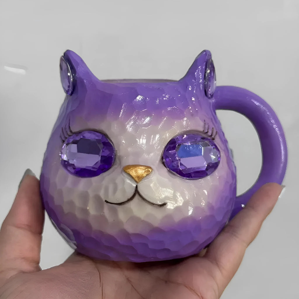 Clear resin Cat Cup ornament in purple, green, blue, and pink colour options on display.