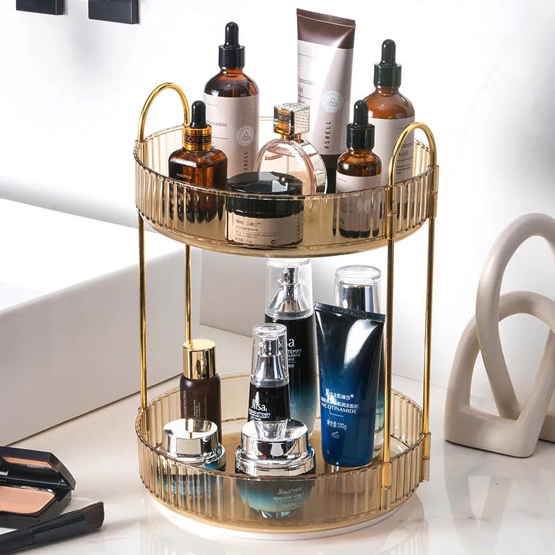 Three-layer rotating bathroom cosmetics storage rack in green on a desktop, with bottles on each tier.