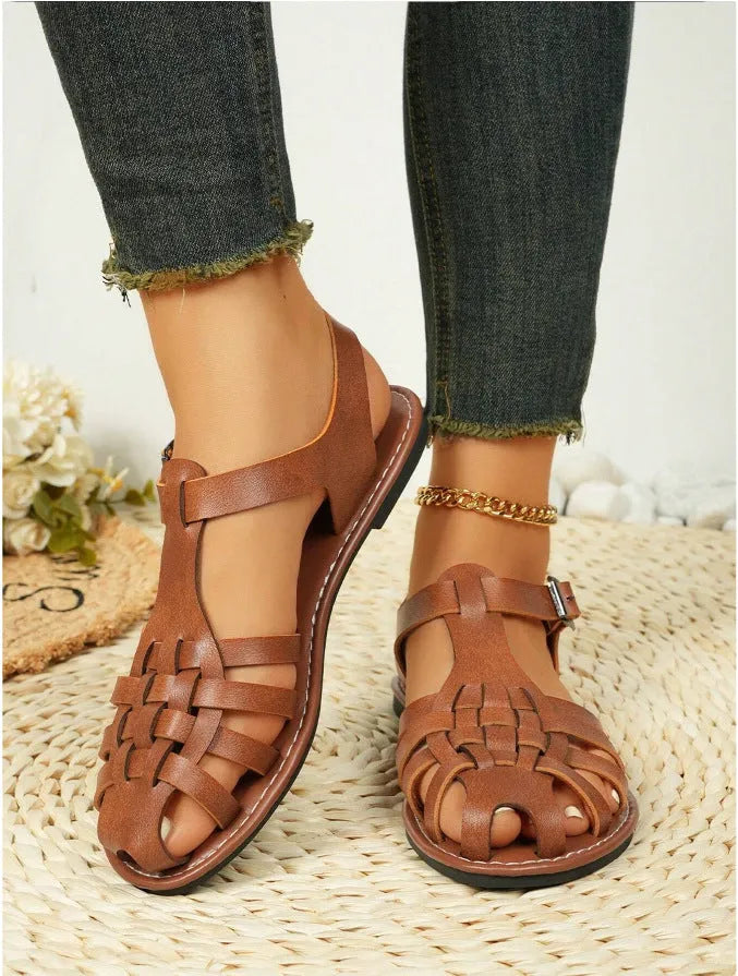 Dark brown women's vintage weave roman sandals with closed toe and buckle fastening on a soft rubber sole.