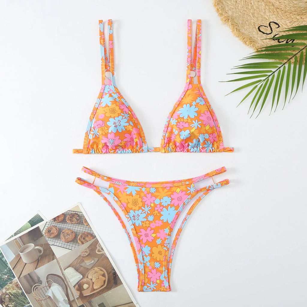 Women's printed halter swimming briefs set in blue, showing top and pants with floral pattern.