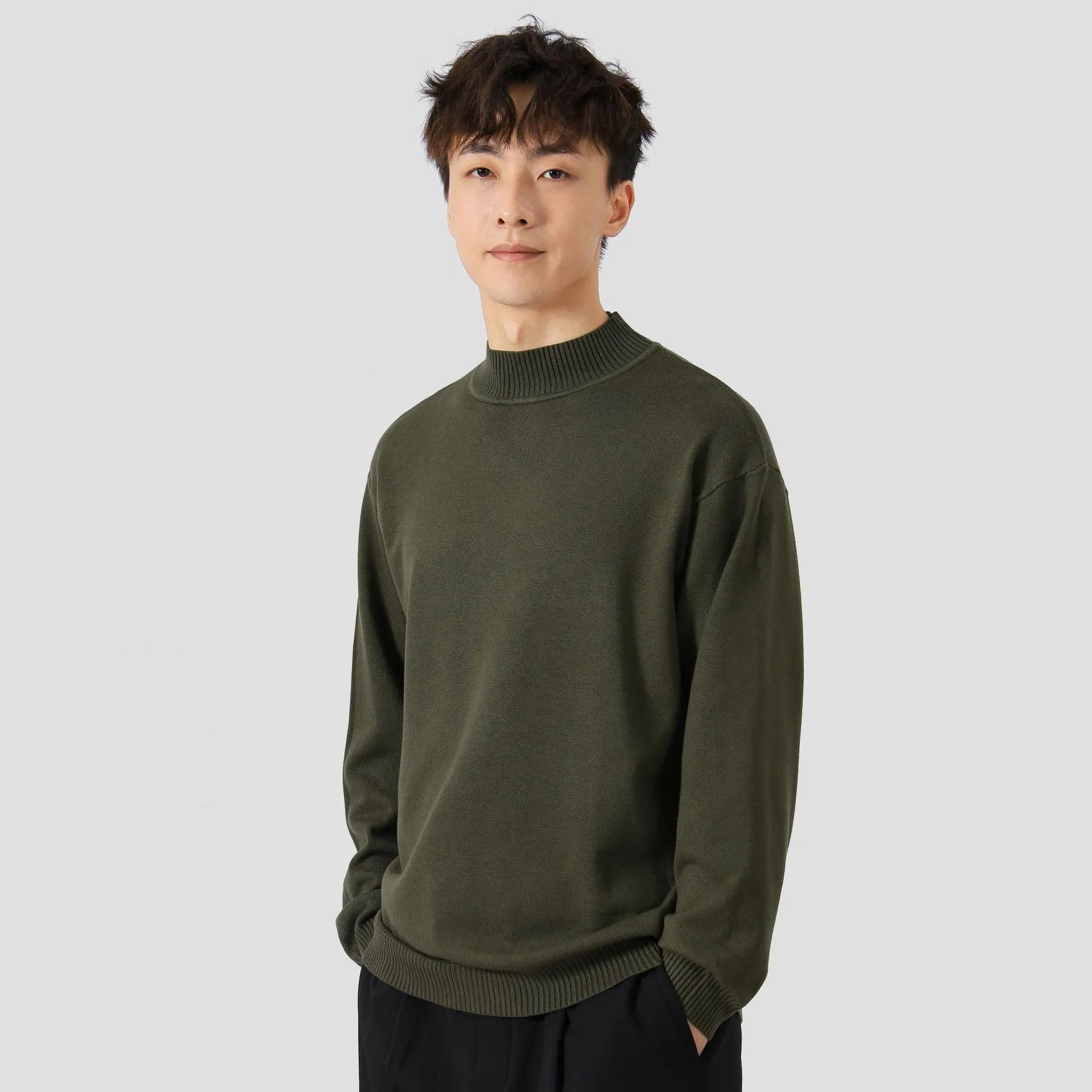 Men's loose fit long sleeve pullover sweater in a neutral colour on a hanger