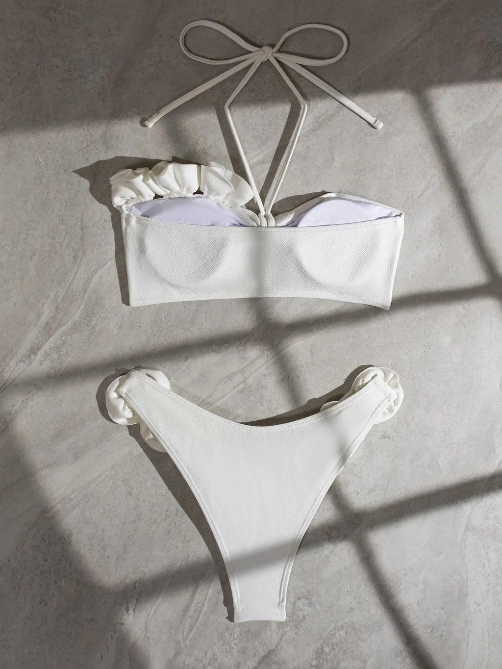 White women's halter lace-up bikini with three-dimensional floral pattern and briefs