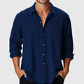Man wearing a loose-fit long sleeve polyester holiday shirt with a stand collar.