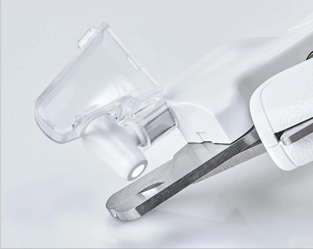 White pet nail clippers with LED light on the handle and a clear anti-splash guard covering the blades.