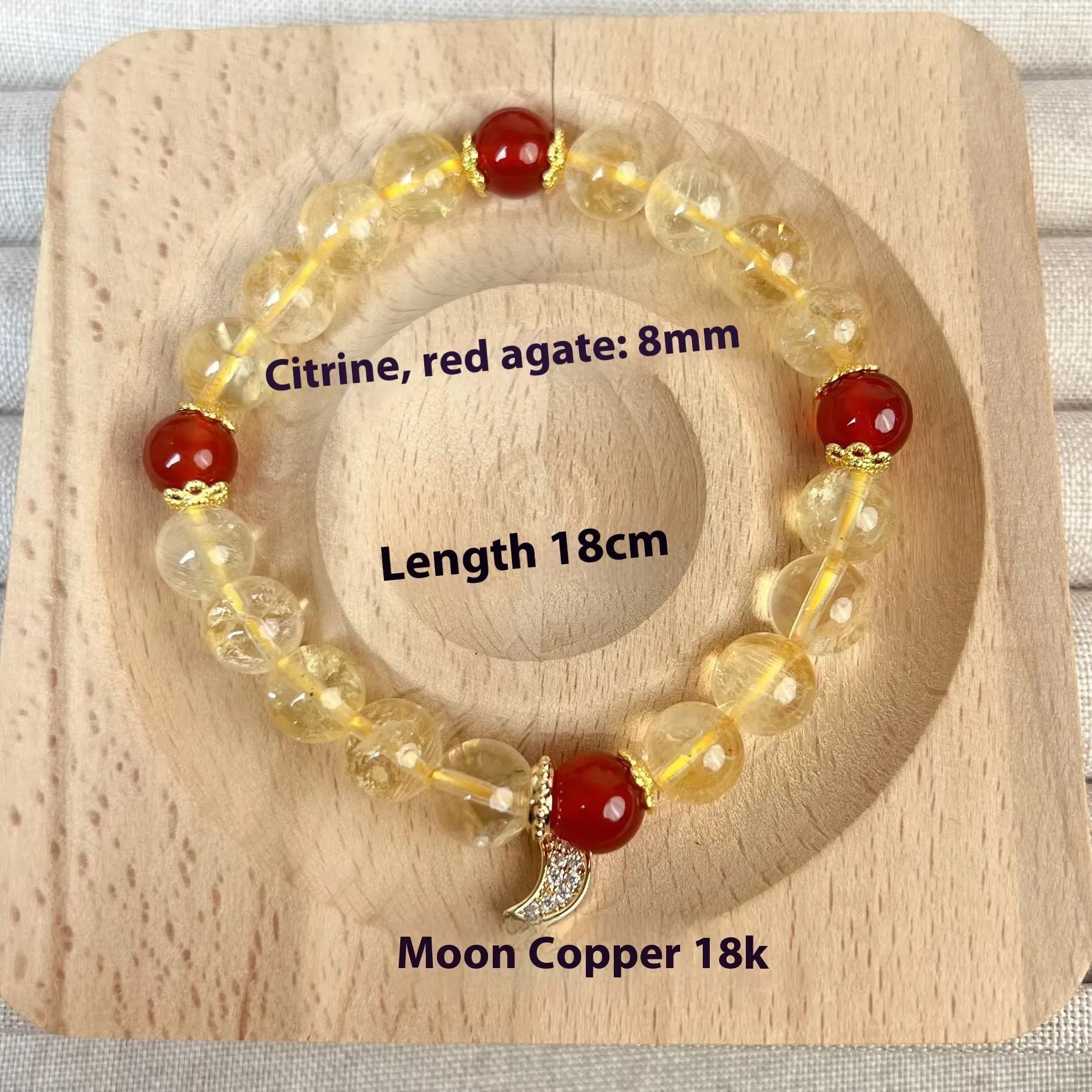 Citrine and red agate crystal moon boom bracelet for women on a white background.
