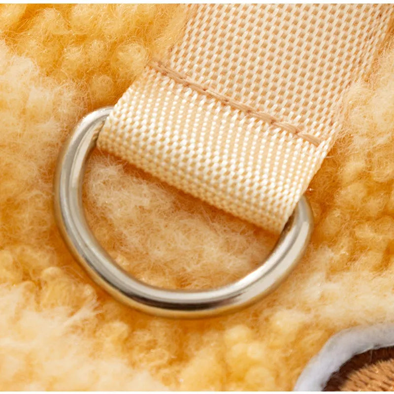 Blue striped lambskin fleece dog coat with drawstring and leash ring on a small dog against a neutral background