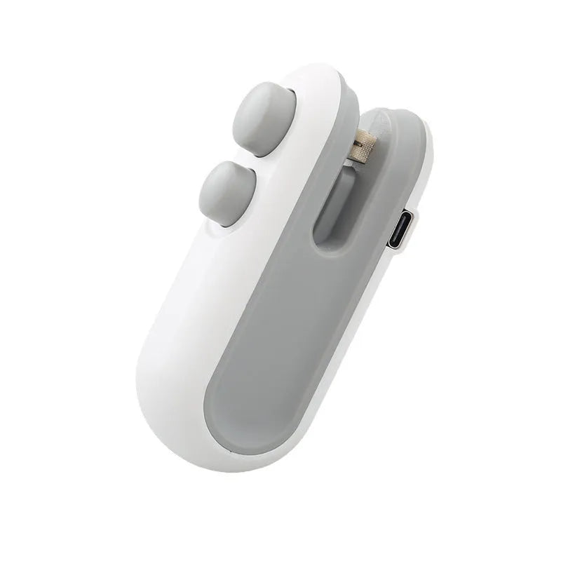 White handheld vacuum sealing machine with USB charging port and magnetic back for chip bags