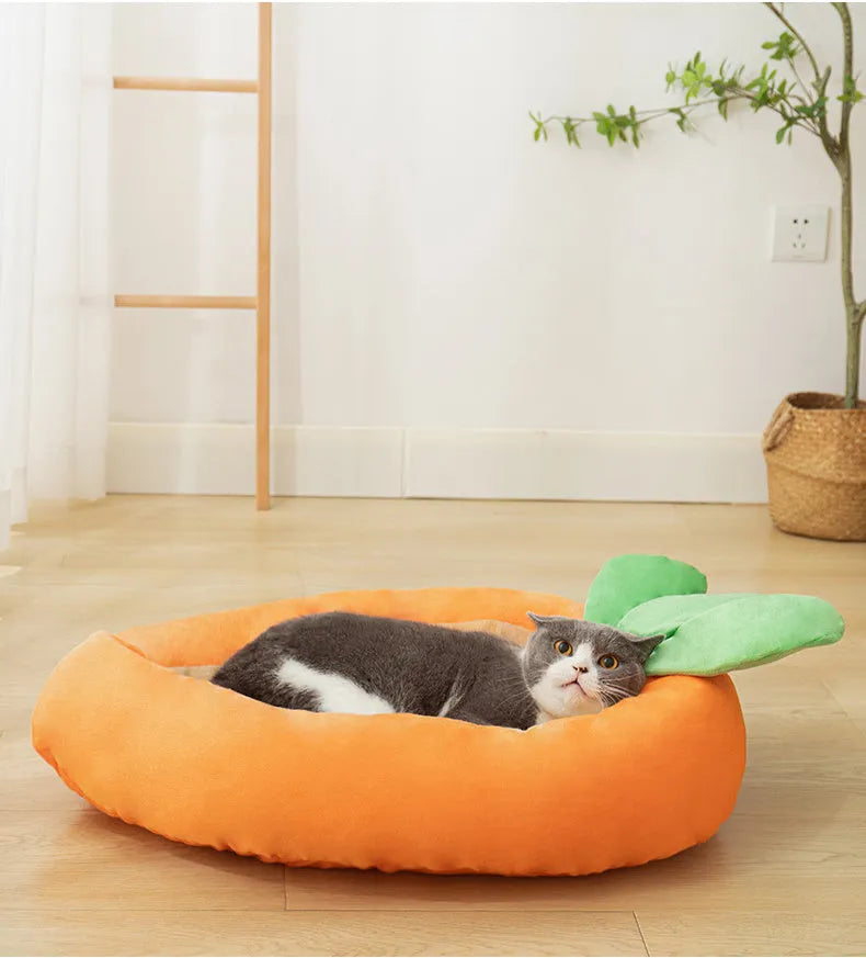 Carrot-shaped dog nesting bed with a soft, light-coloured blanket inside, suitable for a small dog.
