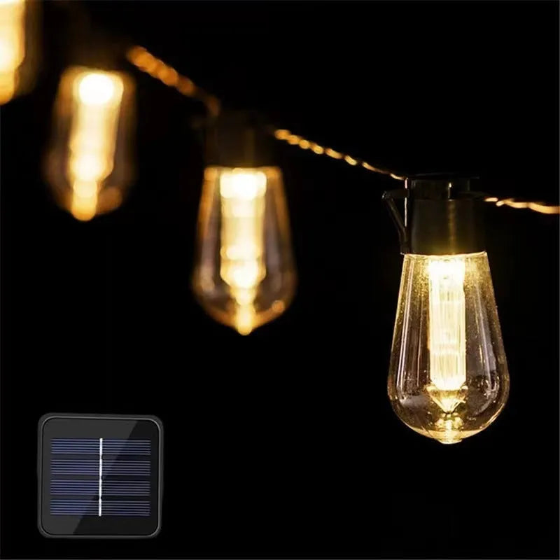Outdoor retro string lights with glass infusion bottle bulbs hung along a black wire.