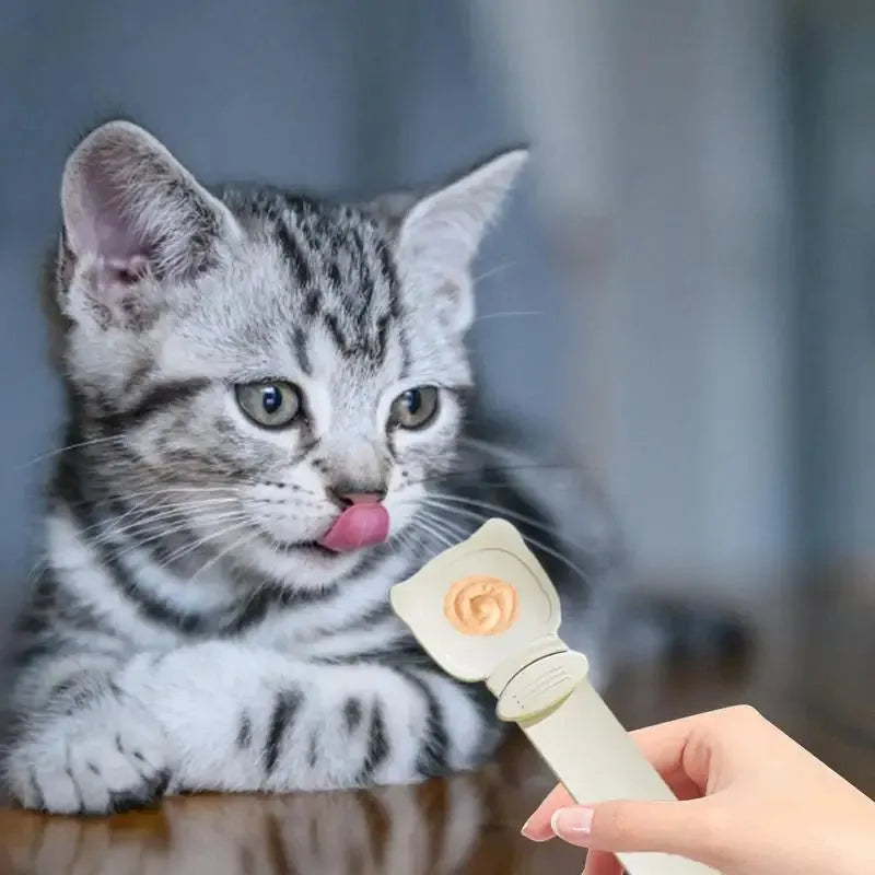 Cat strip feeder spoon in orange, green, and white, 27 x 6.5 cm reusable treat dispenser