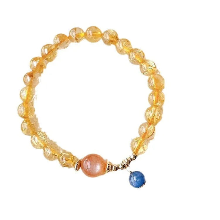 Gold rutilated quartz sunstone crystal bracelet with diamond-shaped beads for women.