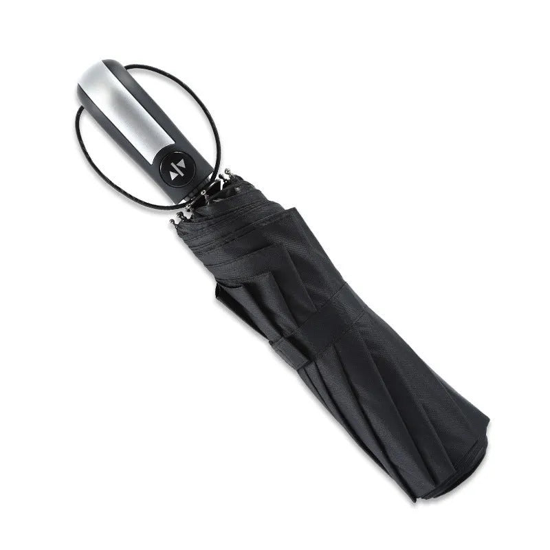 Black triple folding automatic umbrella with steel ribs and a rubber handle, shown open.