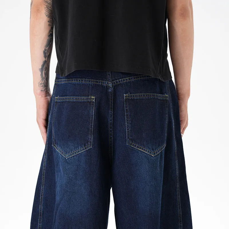 Dark blue women's wide-leg denim jeans with distressed detailing on the legs.