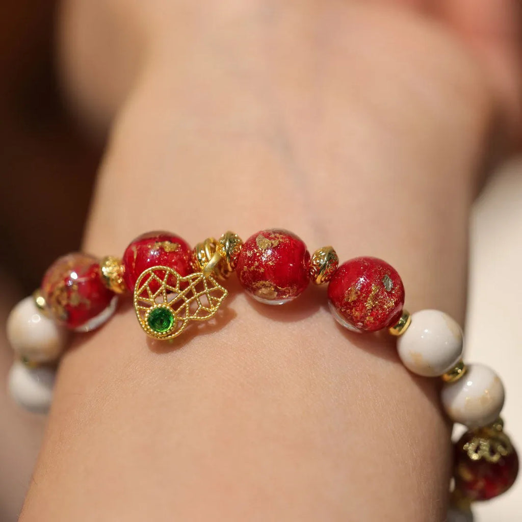 Women's ethnic bracelet with gold foil coloured glaze geometric design in pink or red colour options