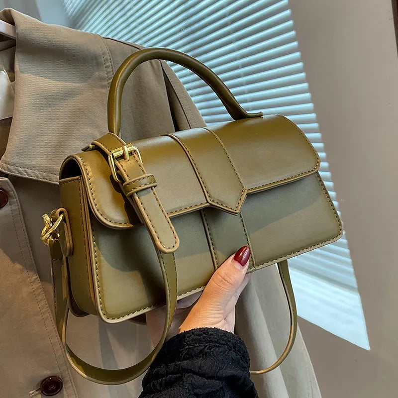 Beige women's square messenger bag with a top handle and shoulder strap, showing an outer pocket.
