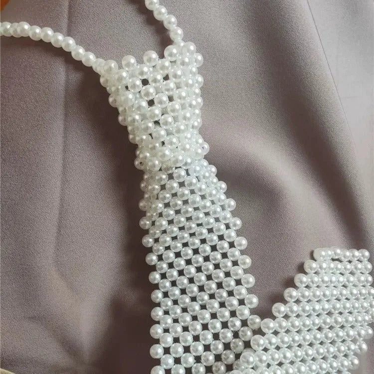Adjustable pearl body chain with hollow-out design and alloy tie clasp in white or black colour