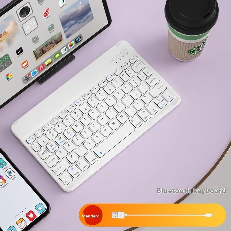 Girls Bluetooth keyboard in Lavender colour on a desk next to a tablet