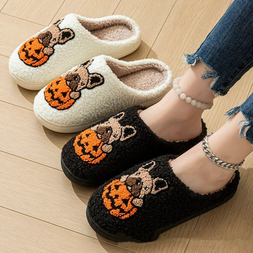 Black and white Halloween slippers with pumpkin pattern, plush lining, and textured non-slip rubber soles.
