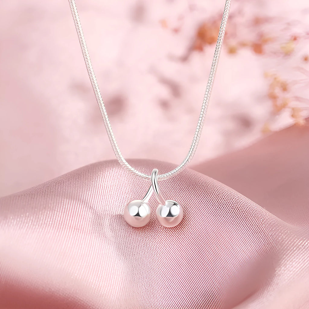 925 silver cherry pendant necklace with an adjustable snake bones chain on a white background.