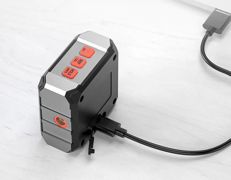 Digital laser infrared woodworking steel tape measure inclinometer with alloy casing on a workbench.