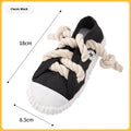 A rock yellow plastic dog chew toy shaped like a slipper, designed for biting and making sound.