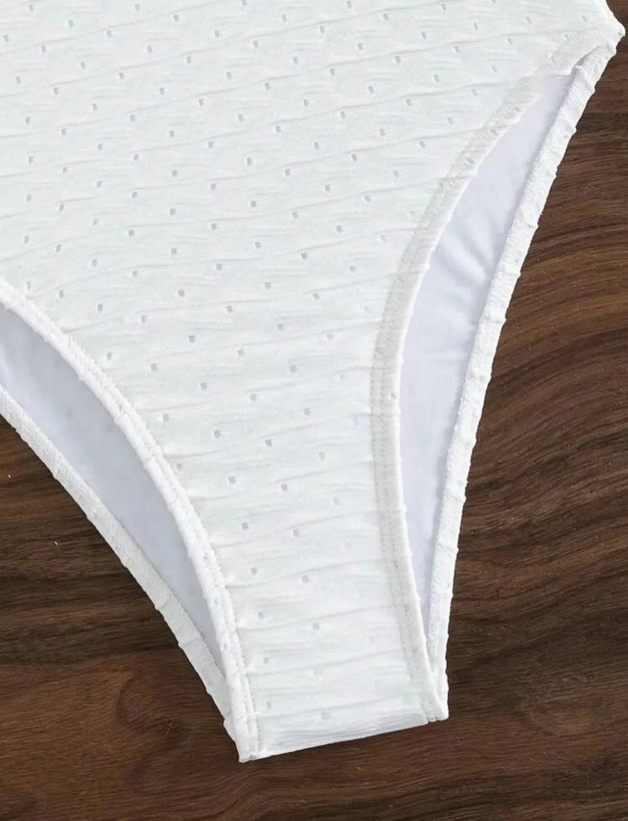 White one-piece swimsuit for women with sling back and briefs cut on a mannequin