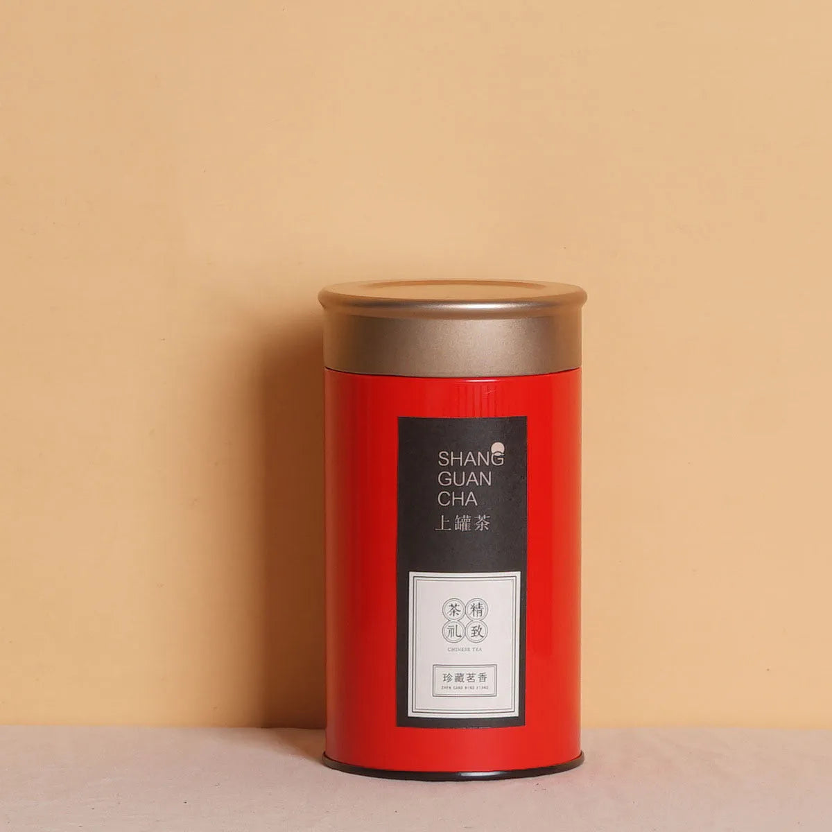 Green metal tin can tea packing box with sealed lid showing measurements of 155mm height and 85mm diameter
