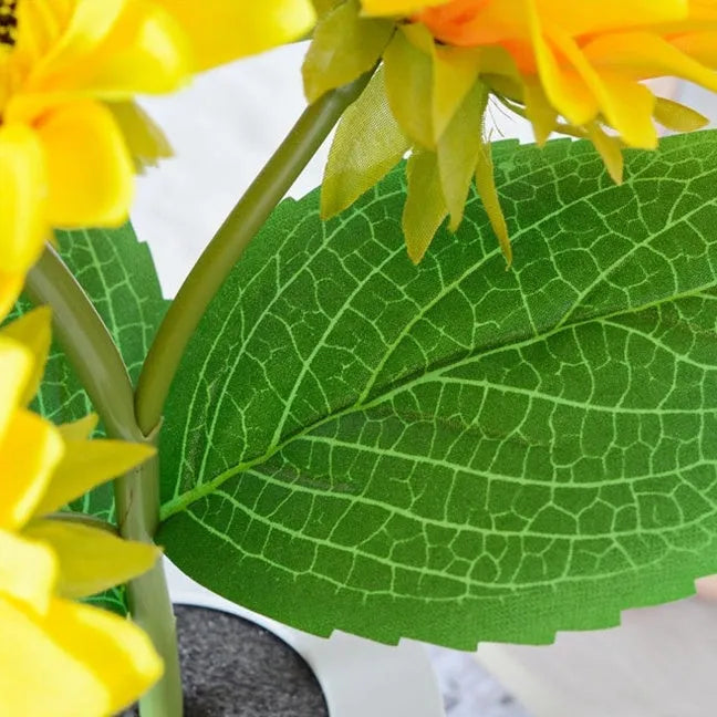 Rechargeable sunflower LED night light with artificial flower design on table