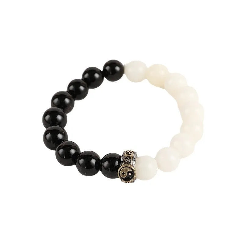 Black and white taiji bracelet with woven obsidian beads showing six word mantra and bagua symbol